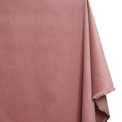 Close-up of a folded piece of pink fabric on a white background