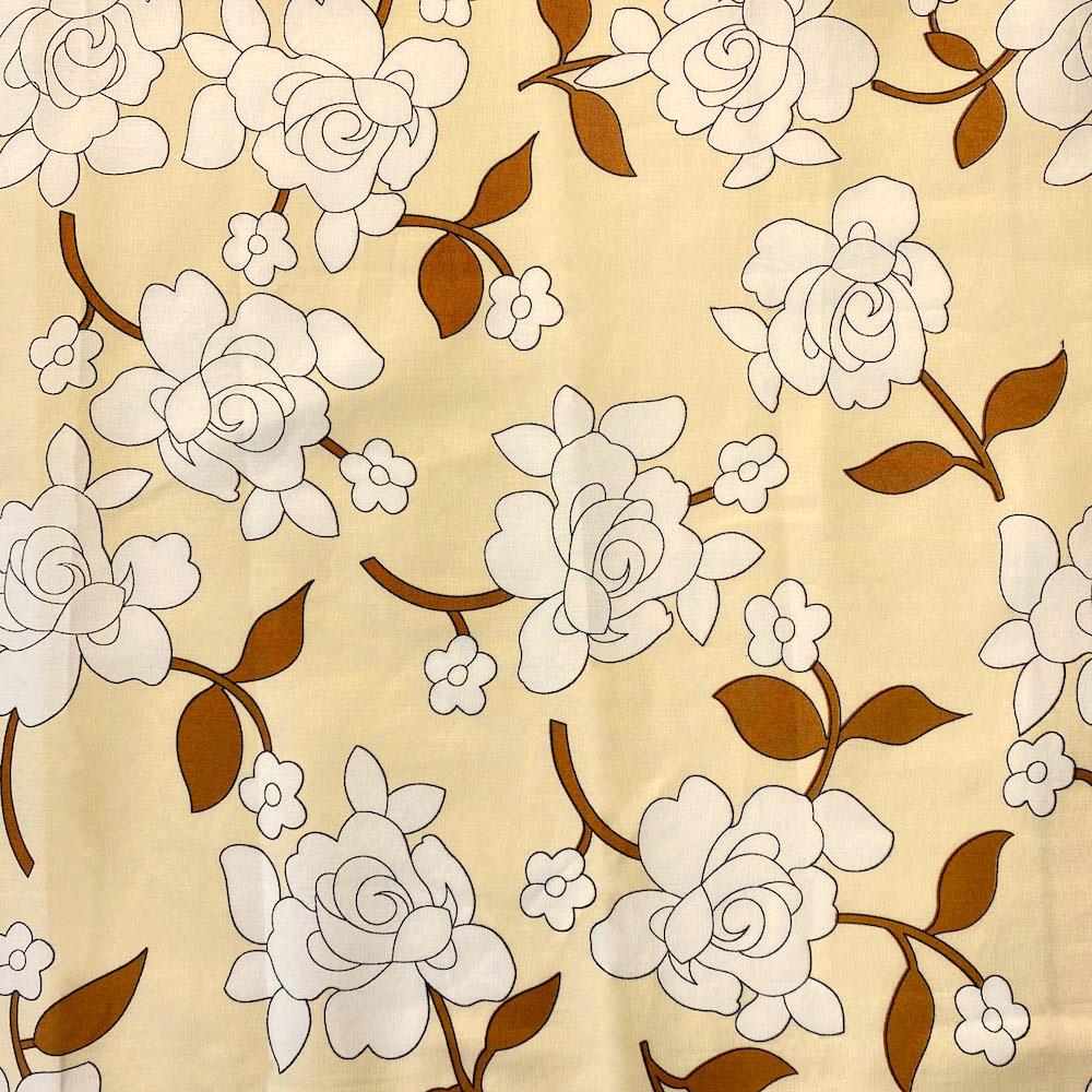 Floral pattern with white flowers and brown leaves on a beige background