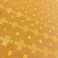 Gold fabric with geometric pattern on a gold background