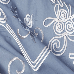 Close‑up of floral embroidery on grey georgette fabric”