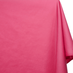 Close-up of pink fabric with a slight texture on a white background