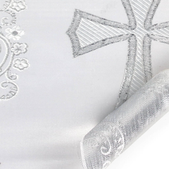 Close-up of embroidered fabric with decorative patterns on a white background
