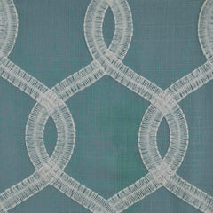Close-up of fabric with a geometric pattern featuring blue, green, and white embroidery | Sold by Beautiful Windows Elgin