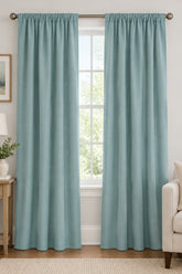 Close-up of green curtain fabric showing its texture and slight sheen.