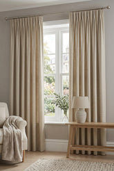 Close-up texture of a beige silk-like curtain panel.