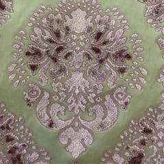 Close-up view of a fabric featuring a green and purple medallion floral pattern| Sold by Beautiful Windows Elgin