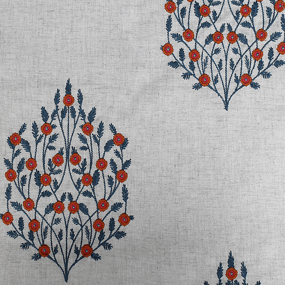 Silk fabric with a traditional floral pattern in shades of blue and red displayed on a white background.
