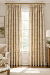 A close-up of a woven fabric with a repeating chevron pattern in beige, cream, tan, and light brown tones.