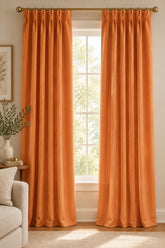 A solid orange colored pleated panel fabric.