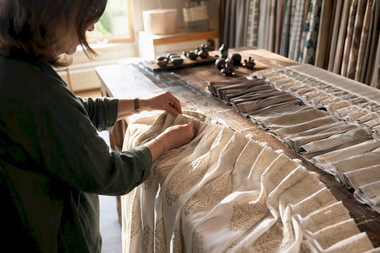 Hands arranging custom curtain headers