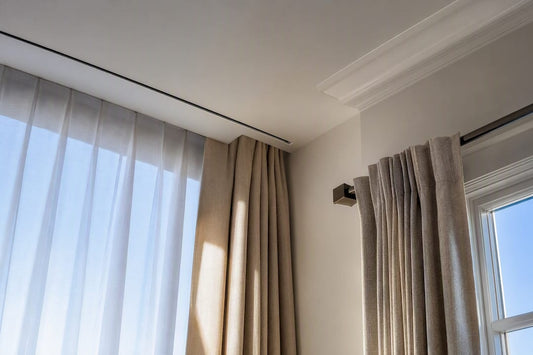 Drapery hardware mounted at ceiling and wall