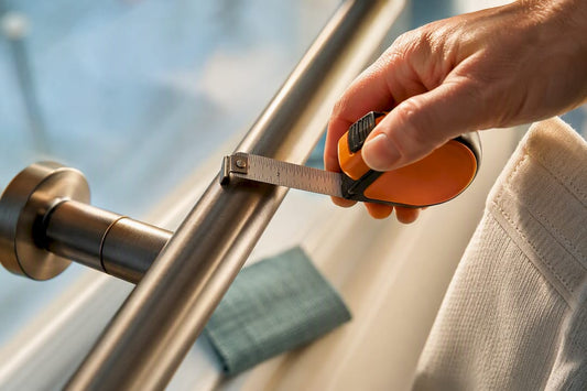 Hand measuring curtain rod diameter
