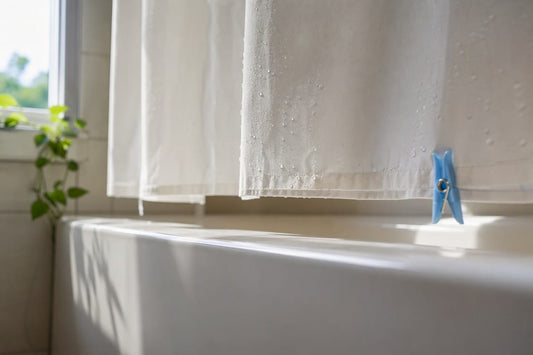 Curtain hem drying above bathtub