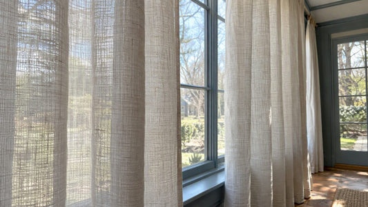 Linen curtains filtering daylight at a window