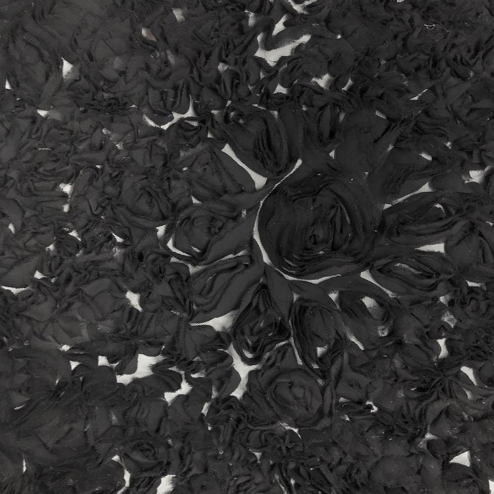 A close-up view of black ruffle georgette fabric on a mesh backing, designed to resemble large daisy flowers| Sold by Beautifulwindowselgin.com