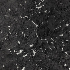 A close-up view of black ruffle georgette fabric on a mesh backing, designed to resemble large daisy flowers| Sold by Beautifulwindowselgin.com