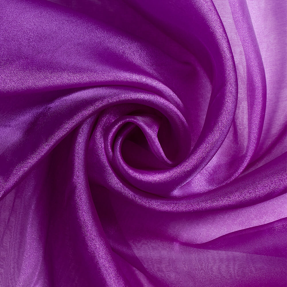 Sheer and sparkling—Purple Tint— Organza Fabric—Composition: 55% Nylon, 45% Polyester—Width 57/58 Inches Wide—Sold by the Yard— Nationwide Shipping Available..