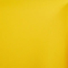 Close-up view of yellow Liverpool bullet fabric with a brick-pattern texture.