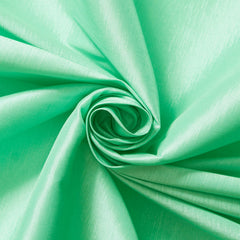 Close-up of green fabric with a swirl pattern Sold by the Yard – Beautiful Windows Elgin USA