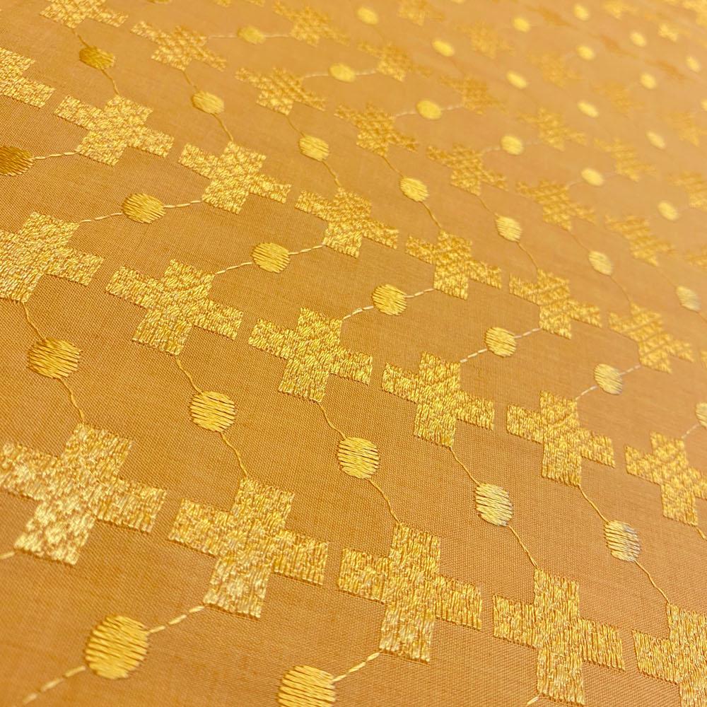 Gold fabric with geometric pattern on a gold background