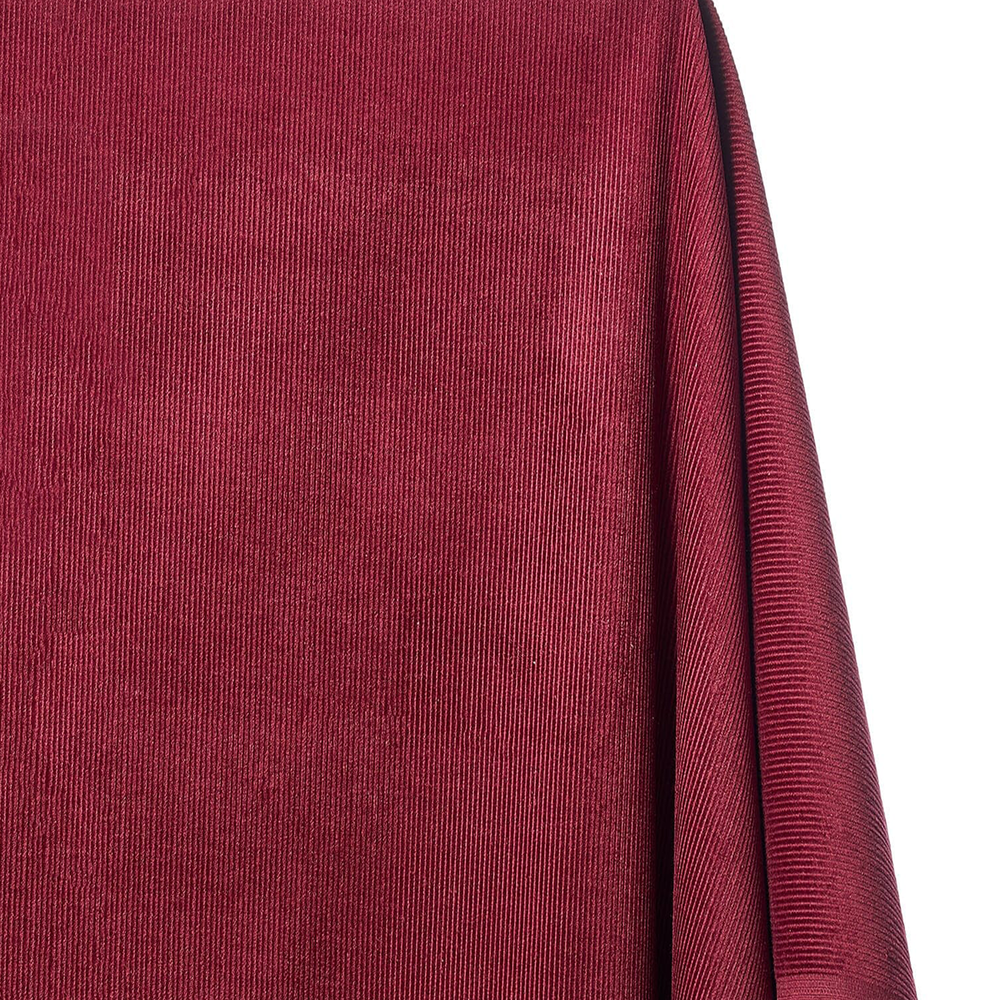 Close-up of a textured red fabric with a white background