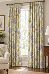 A close-up of a fabric or wallpaper pattern featuring a colorful floral and botanical design on a light cream background. The pattern includes blue, pink, yellow, and green embroidered-style flowers and leaves.