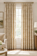A close-up of a woven fabric with a repeating chevron pattern in beige, cream, tan, and light brown tones.